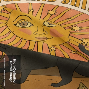 Macro detail of sun and cat tapestry showing fine woven fabric texture and print quality