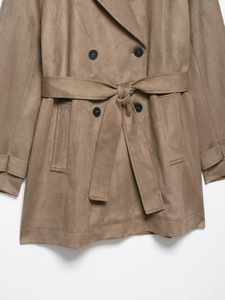 Close-up of suede trench coat waist with tied belt and double-breasted buttons