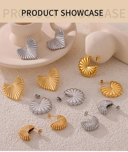 Close-up of gold and silver plated earrings with pleated wavy texture and fan design