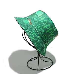 Detail view of St. Patrick's Day bucket hat with green shamrock patterns and holiday text