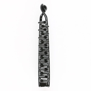 Detail view of large black glossy plastic banana hair clip with multi-tooth structure