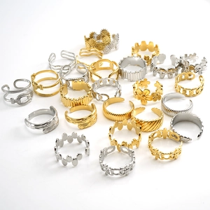 Assorted minimalist 18k gold and silver stainless steel open rings on white background