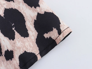 Close-up of leopard print fabric with precise stitching details on vintage dress