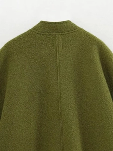 Macro detail of olive green bomber jacket collar and textured wool blend fabric