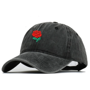 Vintage washed charcoal grey baseball cap with embroidered red rose on a white background