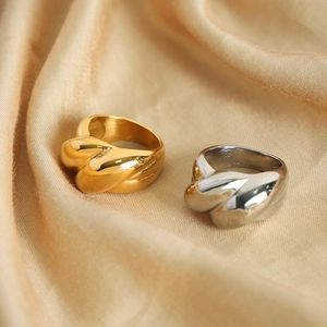 Polished titanium steel geometric twisted rings in gold and silver finish on silk