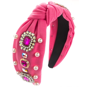 Makroaufnahme von rosa Knotenstirnband mit Türkisglassteinen und Perlendetails