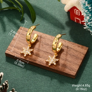 Detailed size display of gold snowflake zircon hoop earrings on a festive wood base