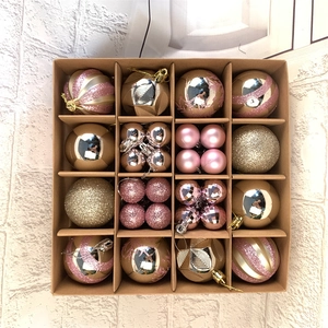 Detailed top view of 42 pink and gold Christmas ball ornaments in a 16-grid craft box