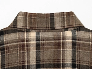 Close-up of the collar on a brown plaid shirt showing high-quality stitching and flannel fabric