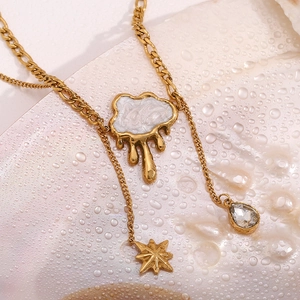 Macro shot of 18K gold plated shell cloud and fringe pendants on double layer chain