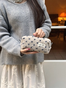 Vue détaillée de la trousse en peluche avec motif cœur bleu et texture douce en polaire