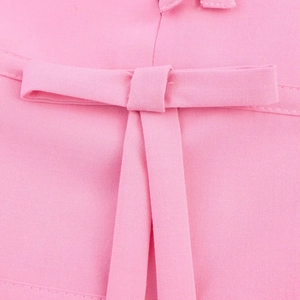 Close-up of pink fabric texture showing high-quality bow decoration and knit craftsmanship