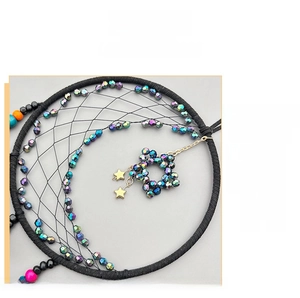 Detail of moon-shaped dream catcher featuring aurora crystal beads and golden star charms
