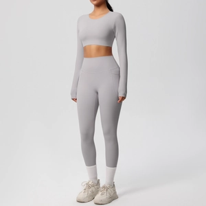 Detail of high-waist yoga leggings with functional side pockets in matte grey fabric