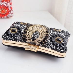 Elegant black evening clutch bag with sparkling rhinestones and golden peacock feather emblem