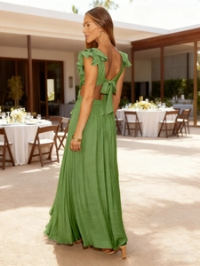 Detail of green floral maxi dress featuring ruffles, backless cutout and bow tie closure