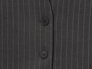 Close-up of charcoal grey pinstripe vest fabric with dual black four-hole buttons
