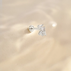 Macro view of 925 silver stud earring with sparkling cubic zirconia stones and tassel chain