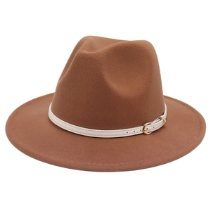 Close-up of brown wool felt fedora featuring white leather strap and gold buckle detail