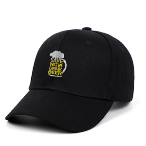 Detailed close-up of beer embroidery and slogan on black cotton baseball cap fabric