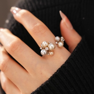 Macro view of a pearl cluster ring with sparkling rhinestones on a silver base