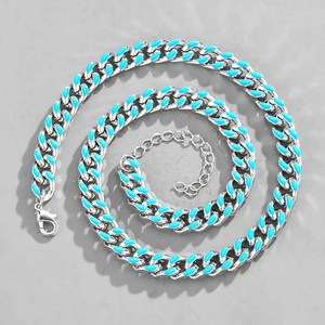 Detail of silver Cuban link necklace with blue enamel accents and extension chain