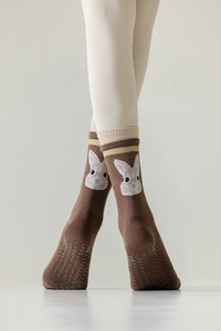 Detail of brown yoga toe socks with anti-slip grip soles and cute rabbit pattern