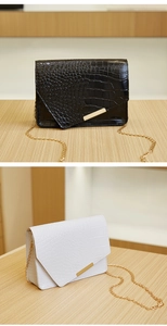 Detail of crocodile embossed small square chain bags in classic black and white colors