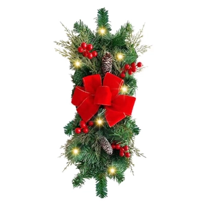 Christmas garland with LED lights, red berries, pine cones and a large velvet bow