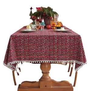 Christmas tablecloth with red plaid snowflake patterns and white pom pom fringe