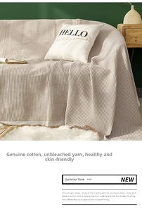 Detail of waffle weave cotton sofa cover with fringe, unbleached natural yarn texture