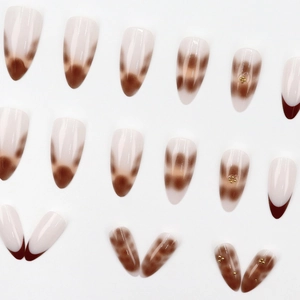 Brown leopard amber press-on nails with cream base and gold micro-bead accents