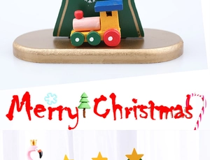 Detail of wooden Christmas tree decor with mini train and Merry Christmas lettering