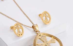 Macro shot of gold-plated cross jewelry set with sparkling rhinestones and delicate details