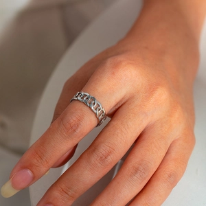 Macro shot of silver titanium steel chain ring texture showing fine metal details