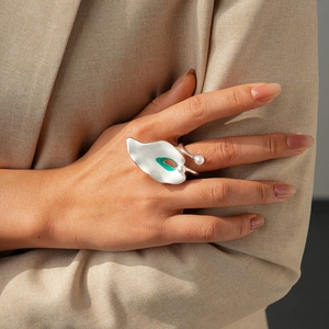 Irregular petal ring with white faux pearls and green enamel in silver finish