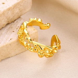 Detailed view of a gold-plated adjustable ring featuring a fluid lava texture on travertine