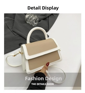 Detail showing contrast color design and sturdy top handle of this minimalist handbag