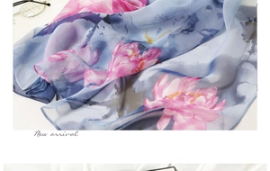 Detail of soft silk scarf featuring pink lotus prints and blue-purple gradient watercolor