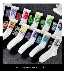 Detail of crew socks featuring motivational graffiti text like WAKE UP and heart patterns