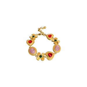 Vintage gold heart and cameo necklace with red and green gems on white background