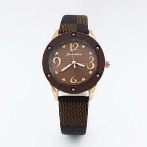 Detail of rose gold case and brown checkered faux leather strap on women quartz watch