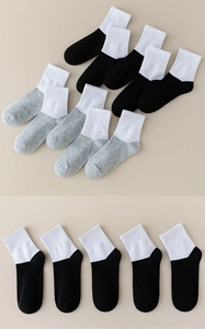 Detail of multi-pack children mesh socks showing black, white and grey ribbing texture