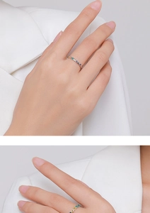 Macro detail of S925 sterling silver rings with colorful star and infinity symbols