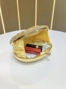 Macro view of the golden sunflower evening bag interior showing yellow satin lining
