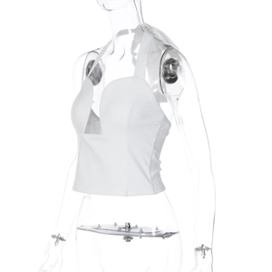 Detailed view of the white halter crop top with a deep V-neck and smooth fabric