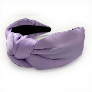 Pale purple satin knotted headband with wide frame and smooth silk texture on white background