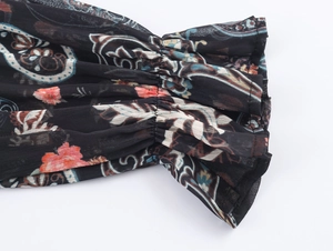 Detail of paisley chiffon dress cuff featuring elastic smocking and ruffle edges