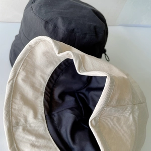 Detail of the water-resistant textured fabric and drawstring on outdoor bucket hats